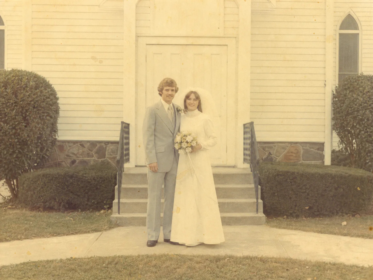 Faded wedding photo before AI restoration